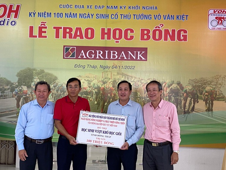 Đại diện Ban Tổ chức cuộc đua và đại diện Agribank trao bảng tượng trưng đến lãnh đạo địa phương