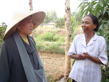 Sư cô Huyền Thanh(trái) lắng nghe chia sẽ với người nghèo .Ảnh LĐL